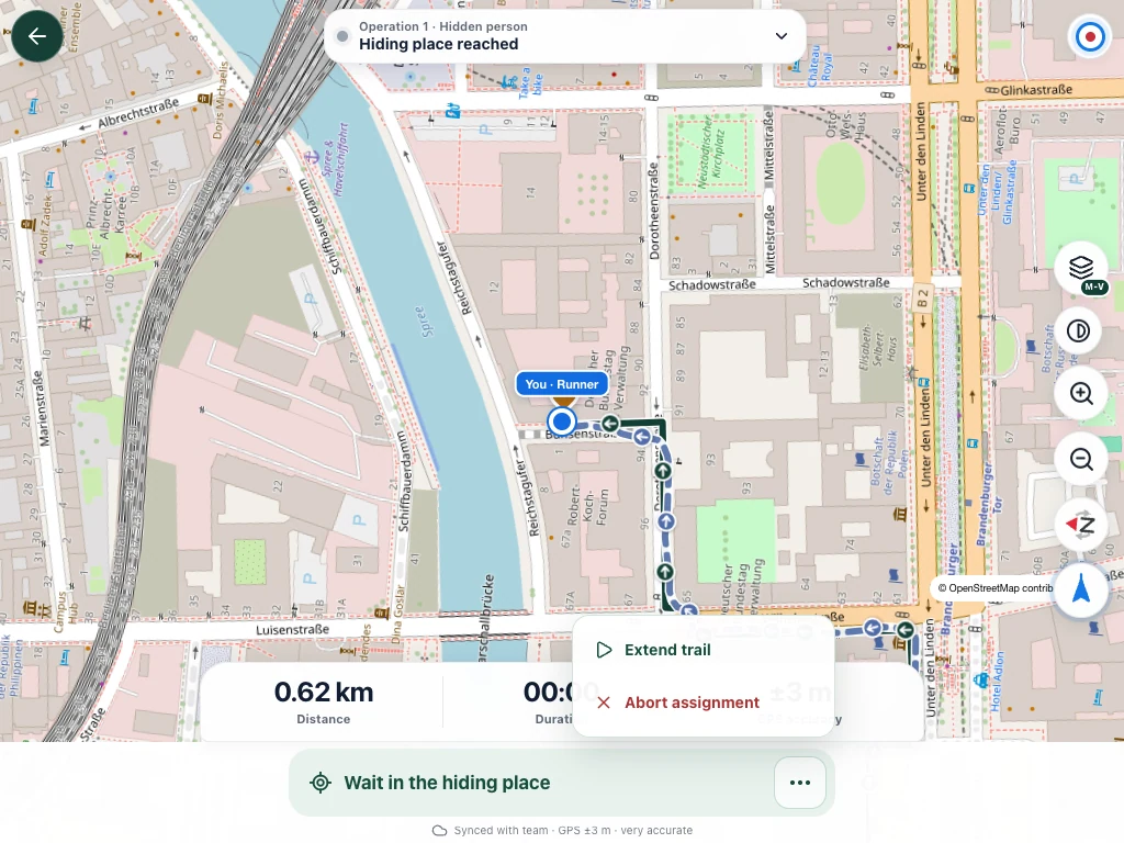 Anna waits at the hiding place. The three-dot menu offers track extension and abort.